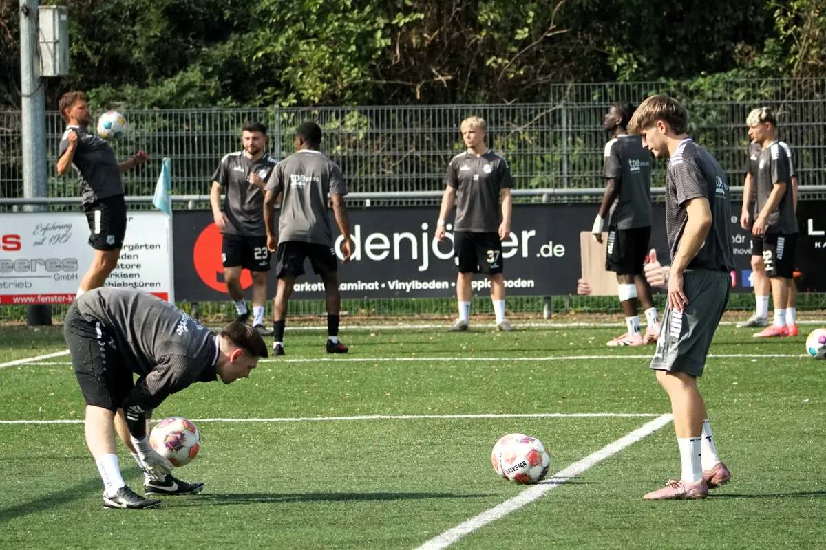 Warming up in front of the advertising boards beside the artificial pitch