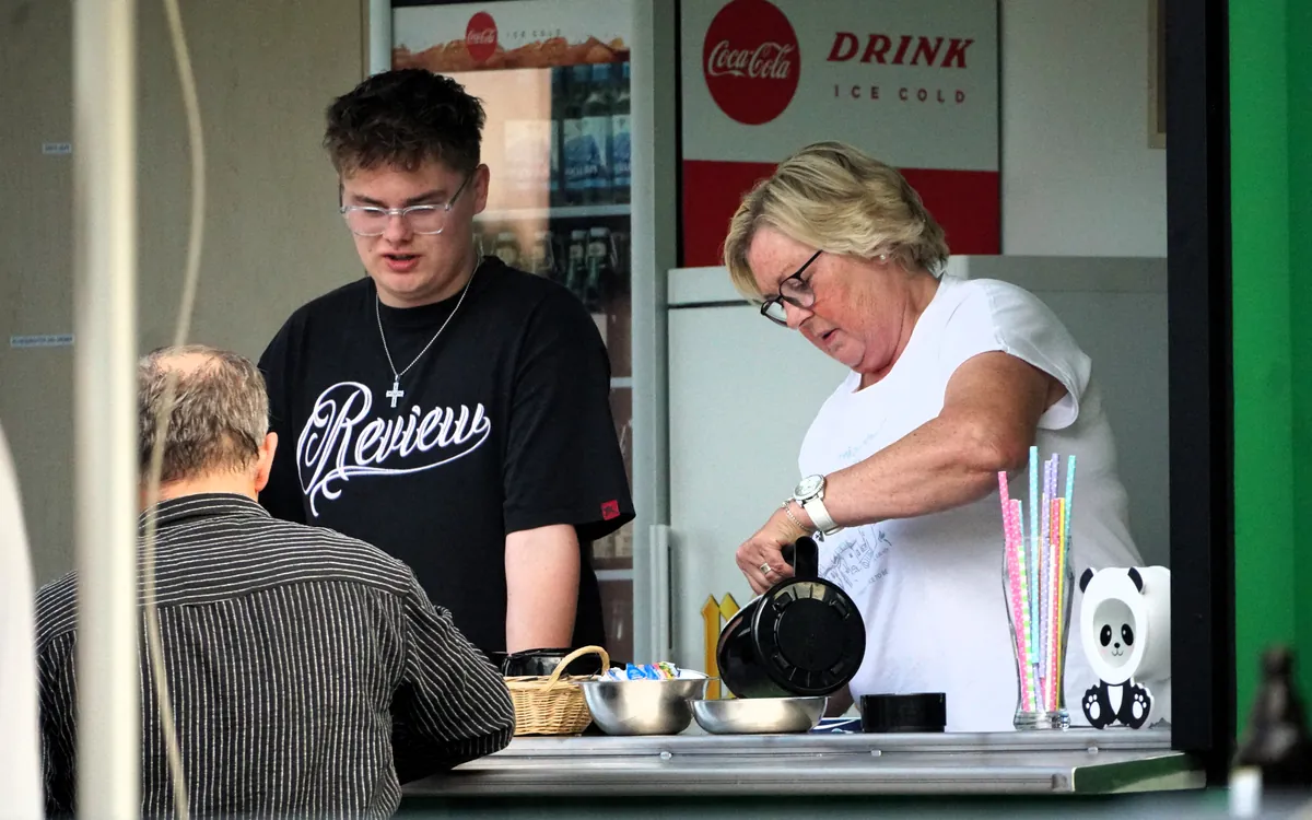 Volunteers behind the bar in the food and drinks container