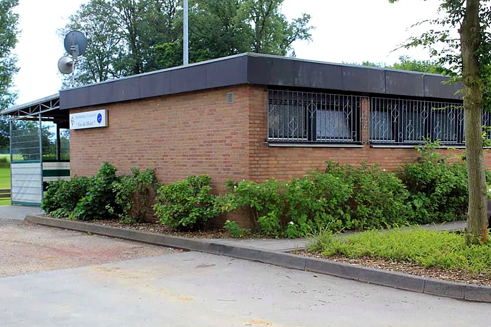 Side view of the clubhouse with flower beds