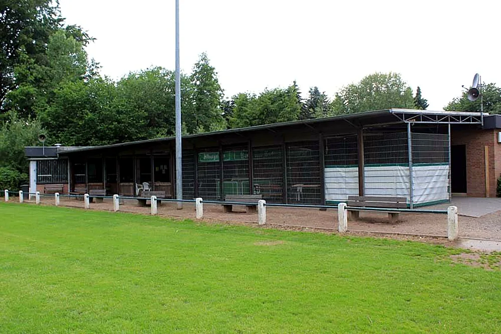 Covered terrace of the clubhouse along the grass pitch